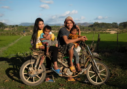 Family riding together in a rural area back home